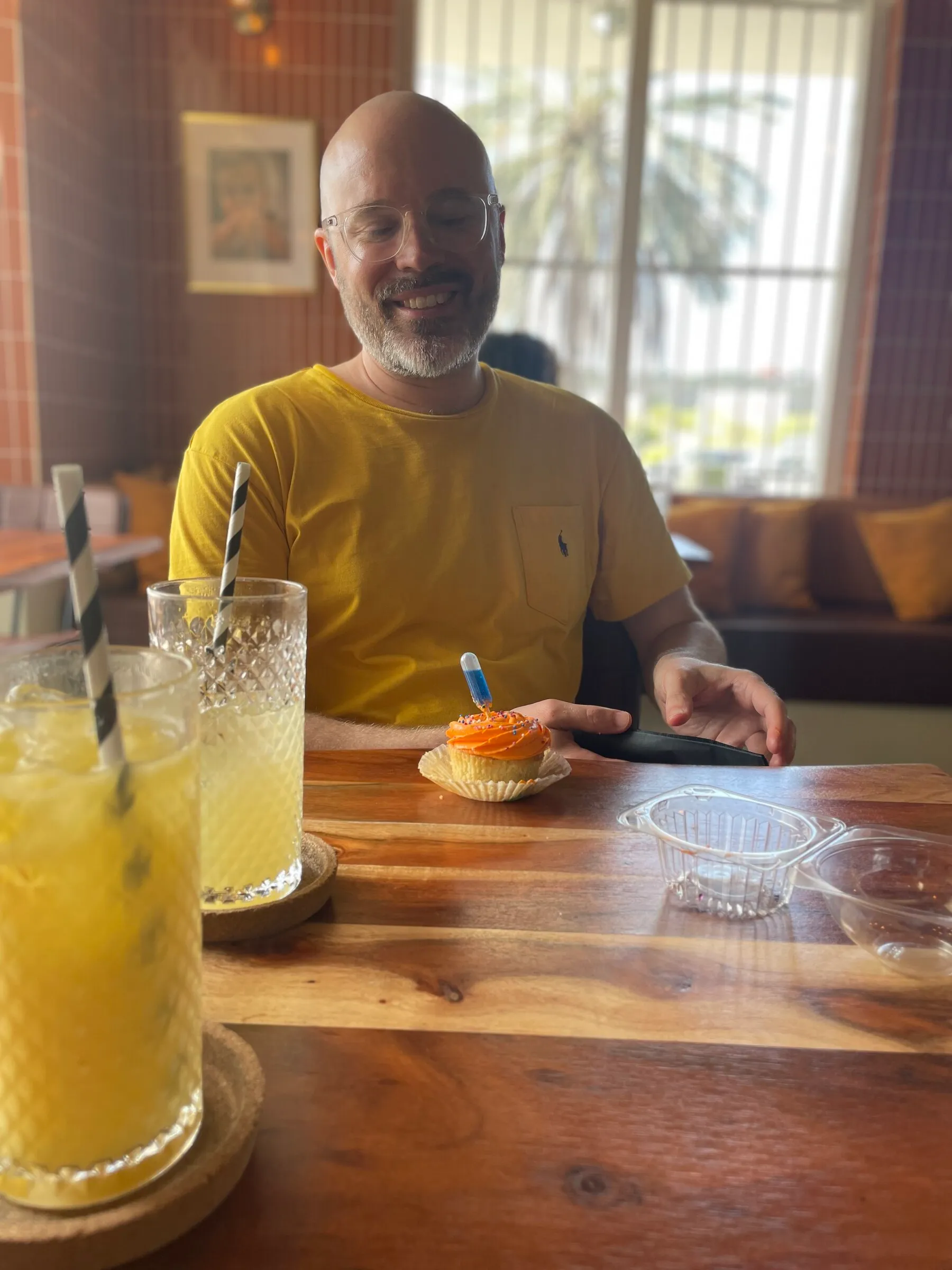 Jesse with a cupcake-shaped cocktail at a restaurant